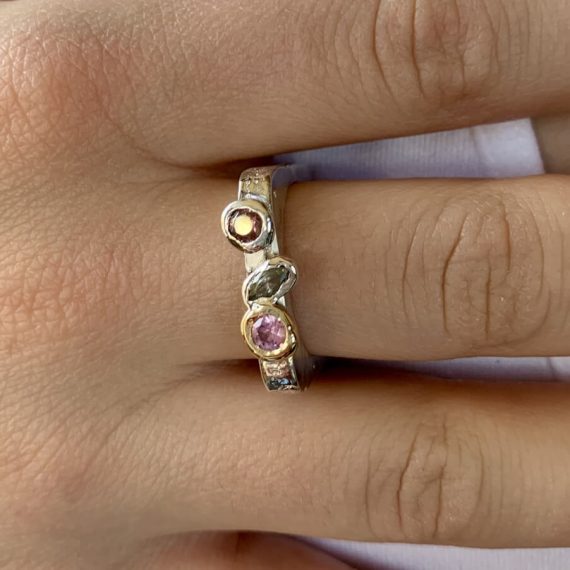 Sand-casted sterling silver ring with a trio of cubic zirconia stones